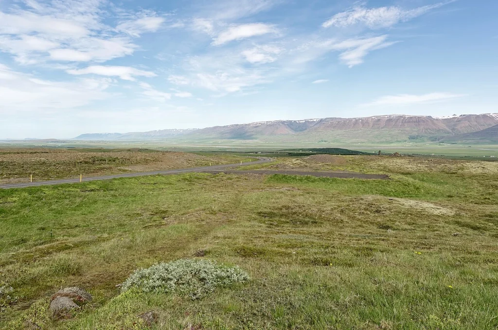 Green valley and distant mountains of Tröllaskagi